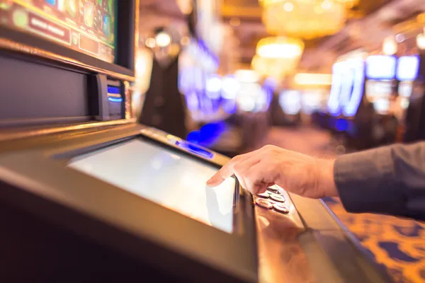 A man focused on his laptop with live stats in the background, highlighting the dedicated sports and gaming features of the PARIPULSE mobile app.